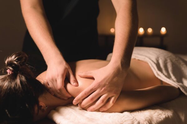 Massage Therapy Massage Therapist Treating Female Client On Table Face Down